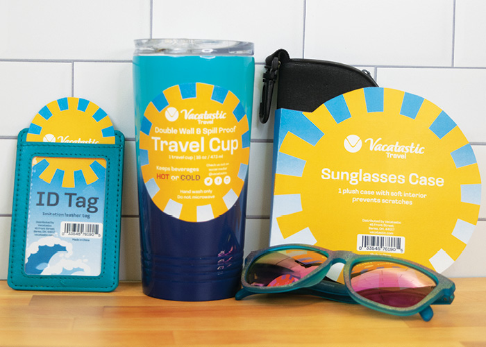 Product photos of ID tag, travel cup, and sunglasses case with Vacatastic branded packaging